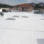 flat roof with roof coating, multiple skylight installations, in a tucson home by a roofing company